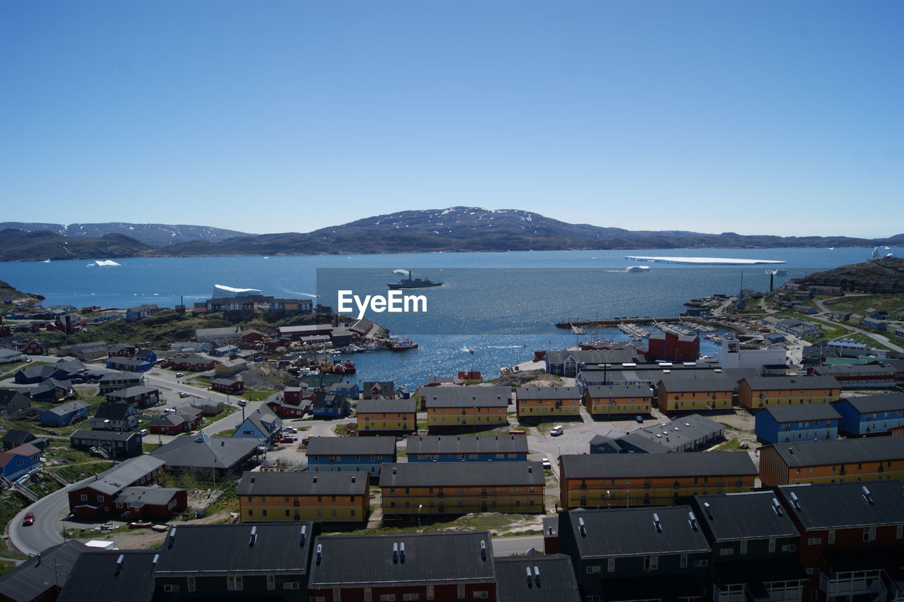 HIGH ANGLE VIEW OF HARBOR BY BUILDINGS IN CITY