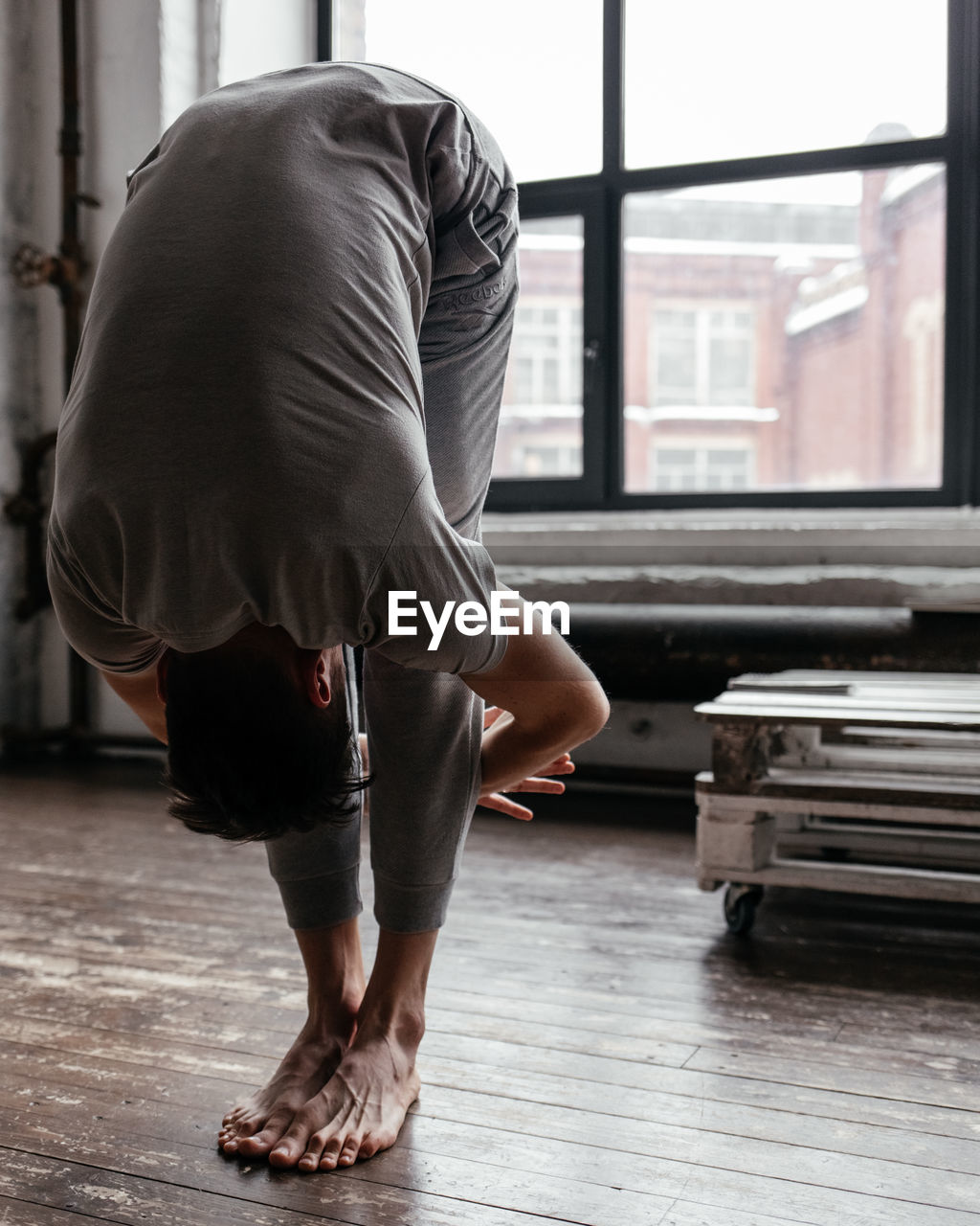 A man with strong body engaged in yoga and meditation, performing asanas