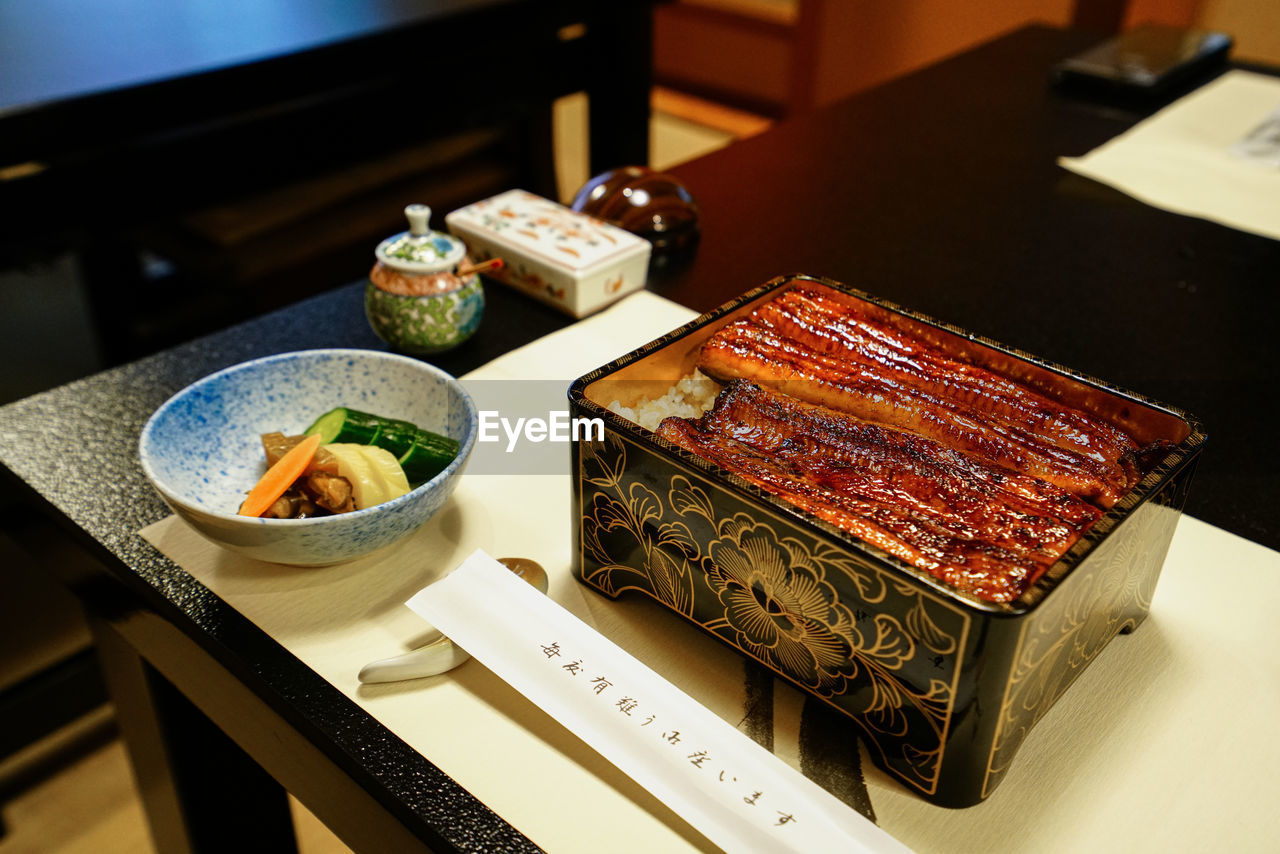 High angle view of eel bowl on table