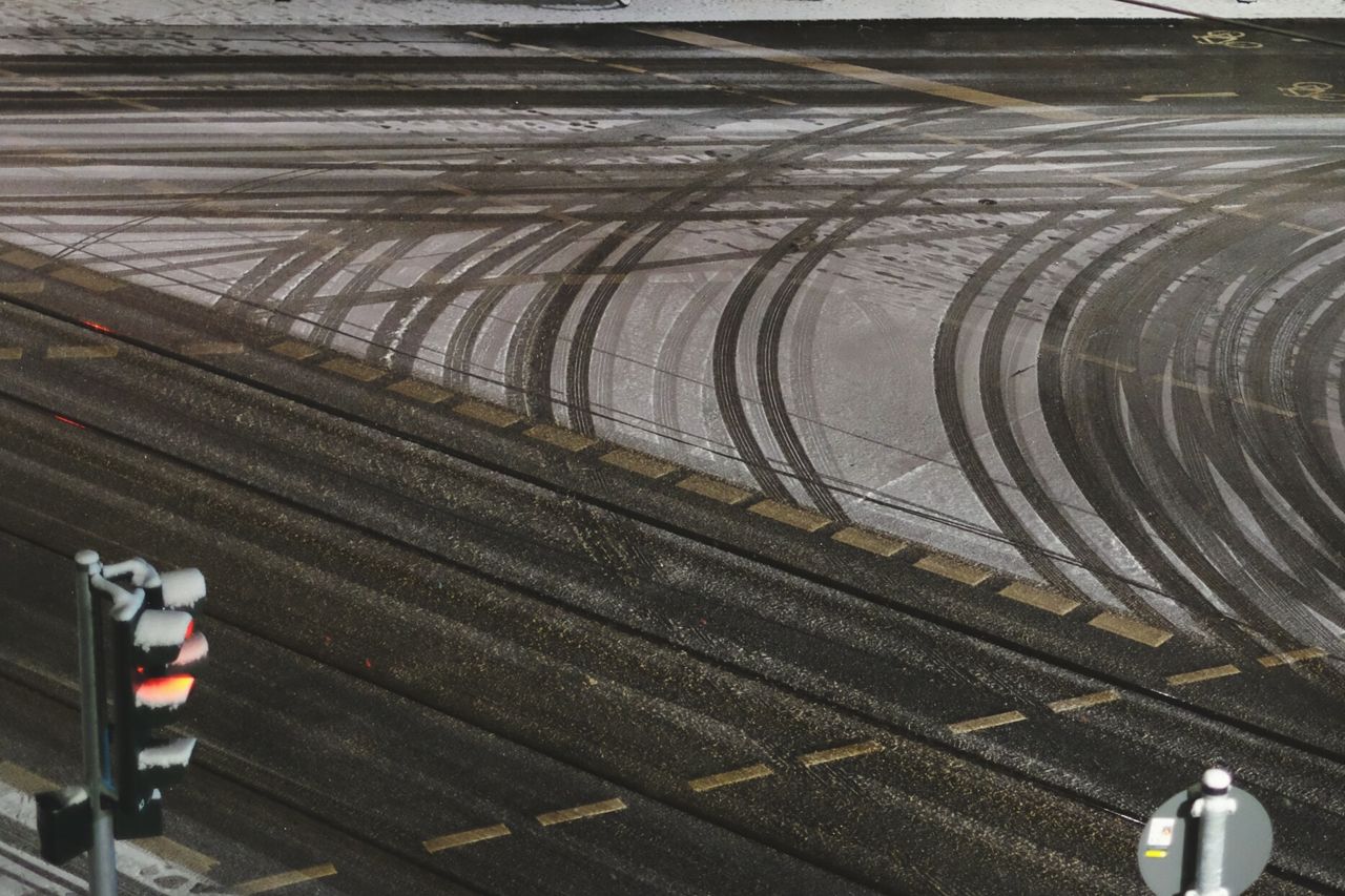 High angle view of tire tracks on empty road during winter