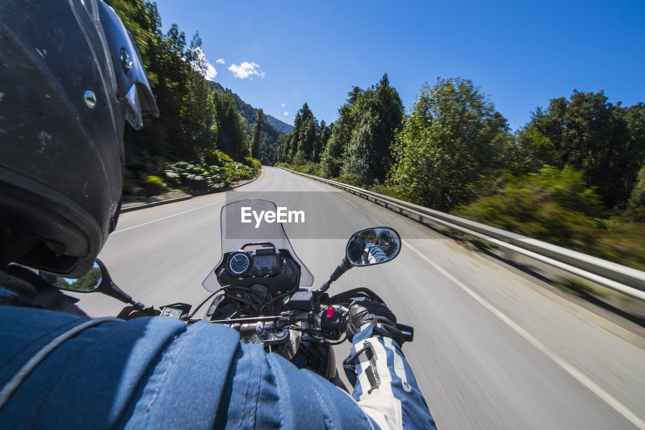 Man driving on a touring motorbike on ruta 7 - the carretera austral