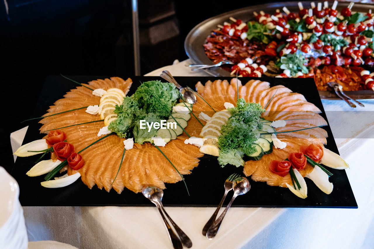 food and drink, food, buffet, freshness, meal, healthy eating, plate, seafood, table, wellbeing, japanese food, high angle view, asian food, flower, dinner, vegetable, indoors, cuisine, serving size, no people, sushi, dish, culture, restaurant, still life, supper, appetizer, rice, gourmet, chopsticks, arrangement, close-up