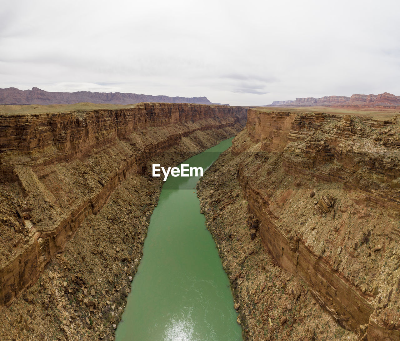 Aerial of the colorado river cutting a green line through the de