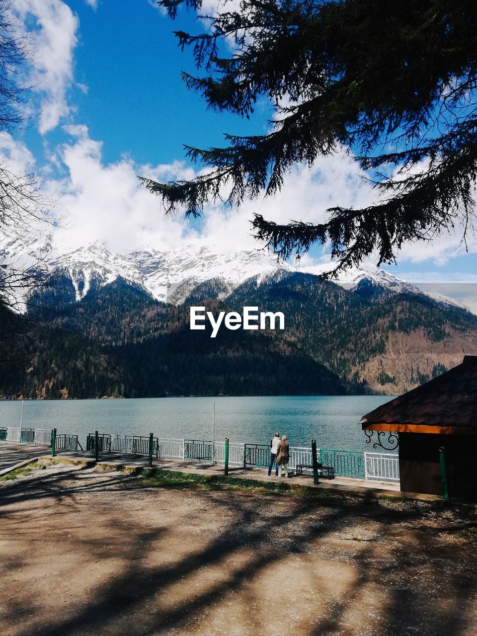 Scenic view of lake by mountains against sky