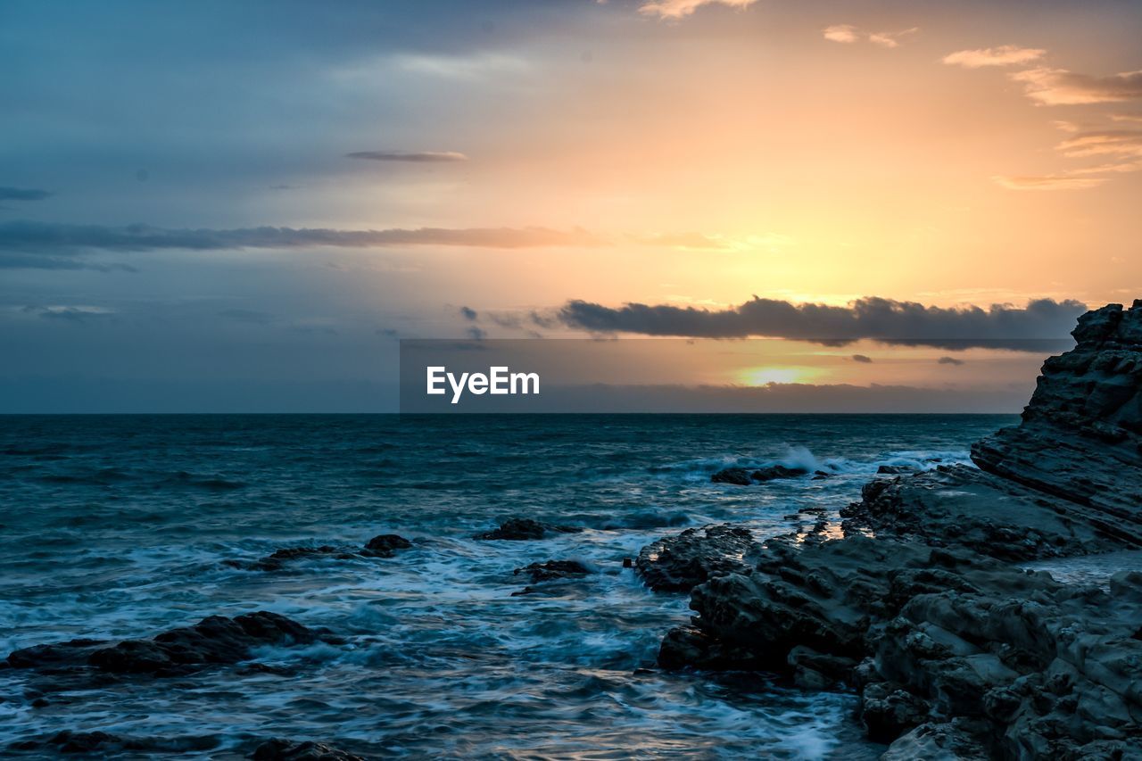 Scenic view of sea against sky during sunset