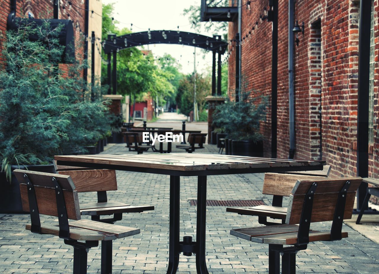 EMPTY CHAIRS AND TABLES IN BUILDING