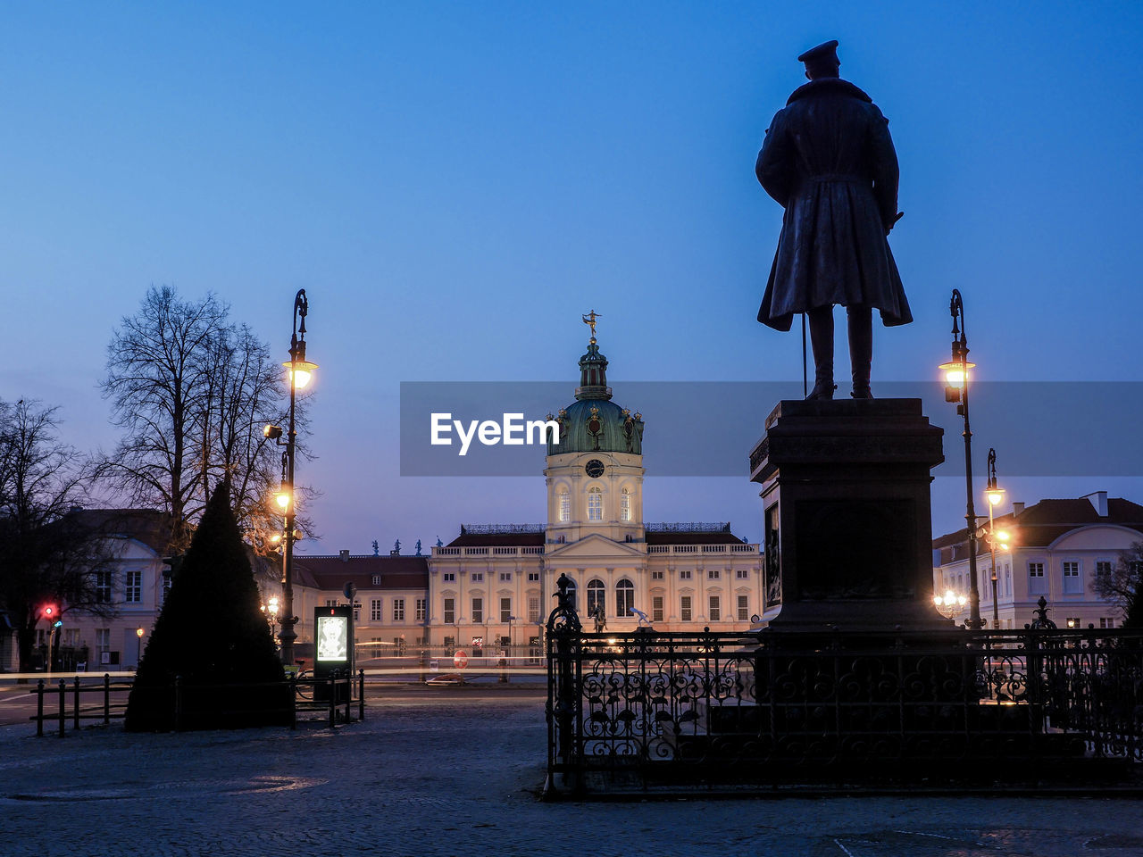 ILLUMINATED BUILDINGS IN CITY AT DUSK