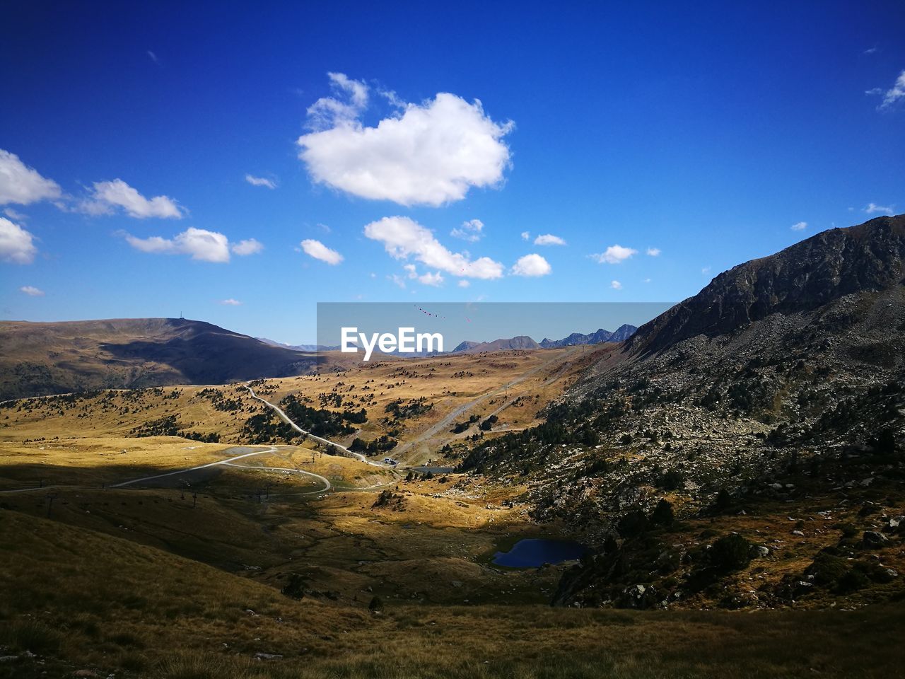 Scenic view of landscape against blue sky