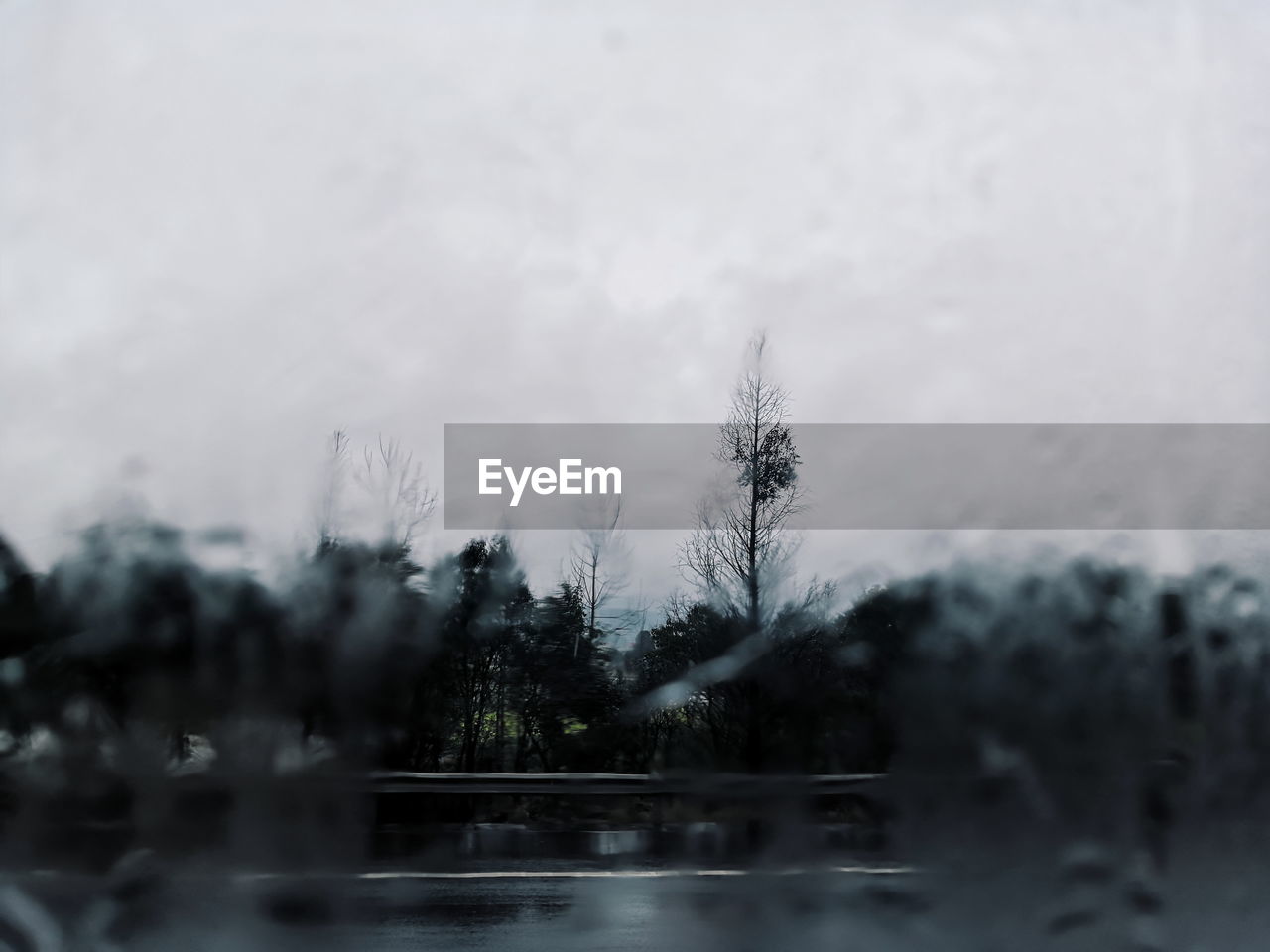 WATER DROPS ON GLASS AGAINST SKY