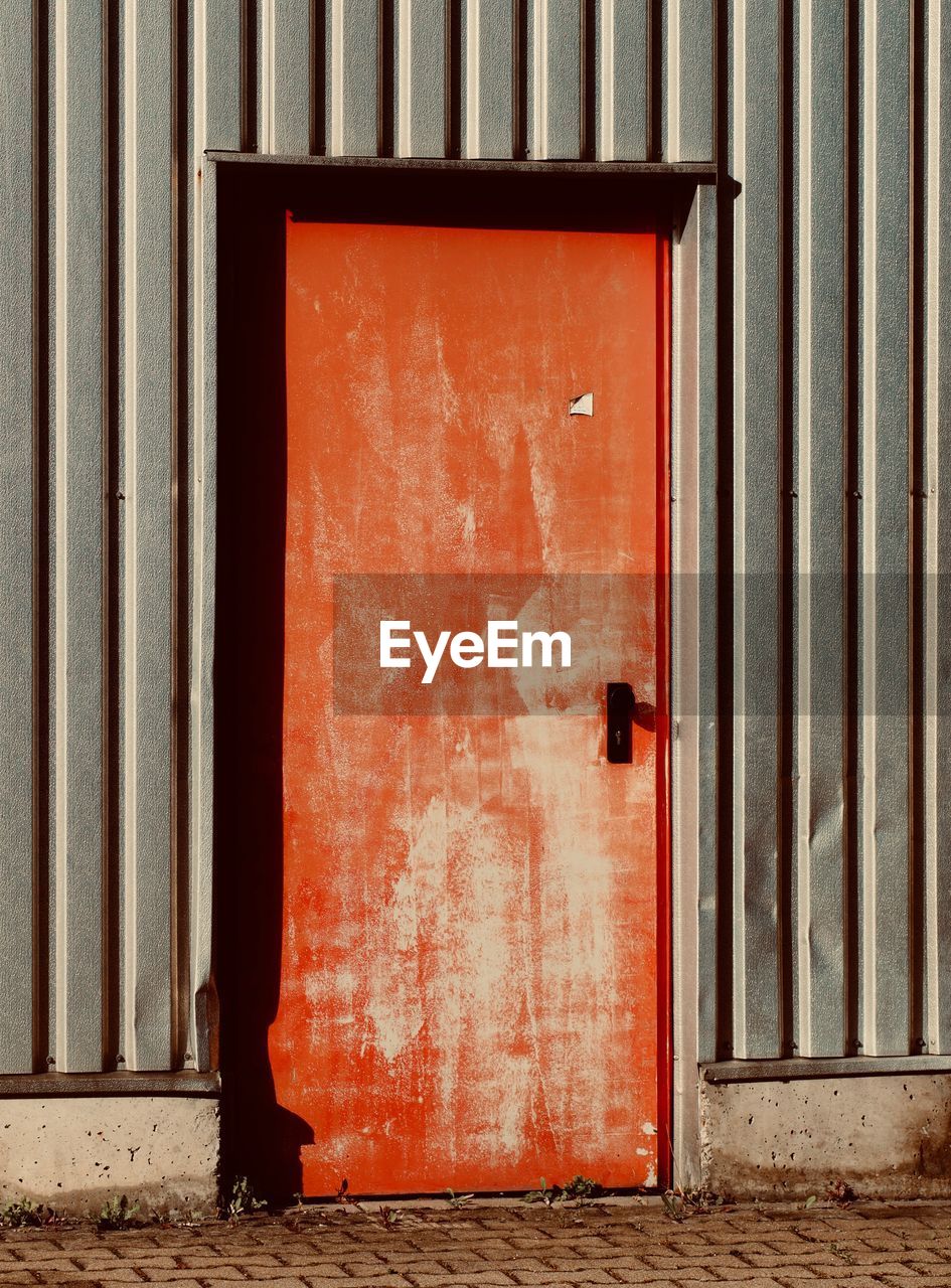 CLOSED RED DOOR OF OLD BUILDING