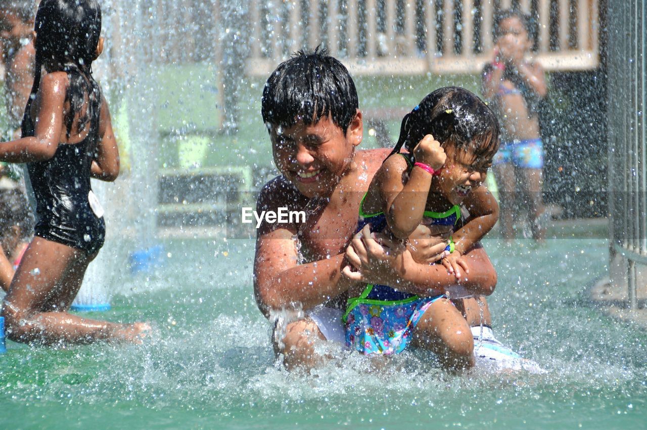 Children playing in swimming pool at water park