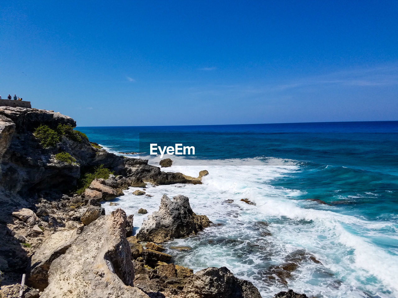 Scenic view of sea against clear blue sky