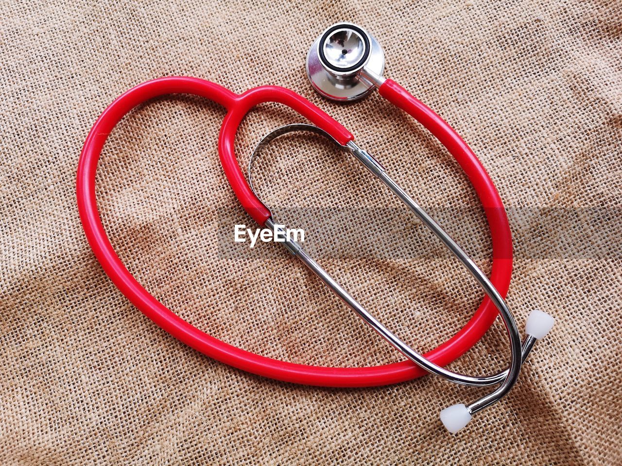 High angle view of stethoscope on burlap