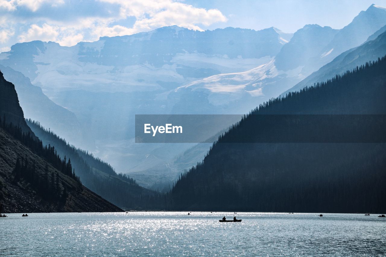 Scenic view of sea and mountains against sky