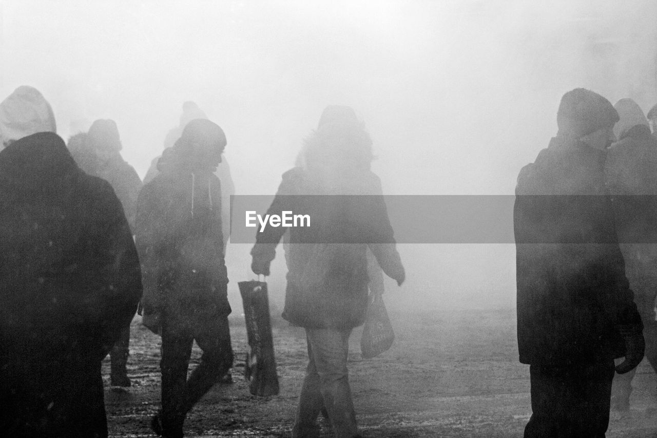 People on road with smoke