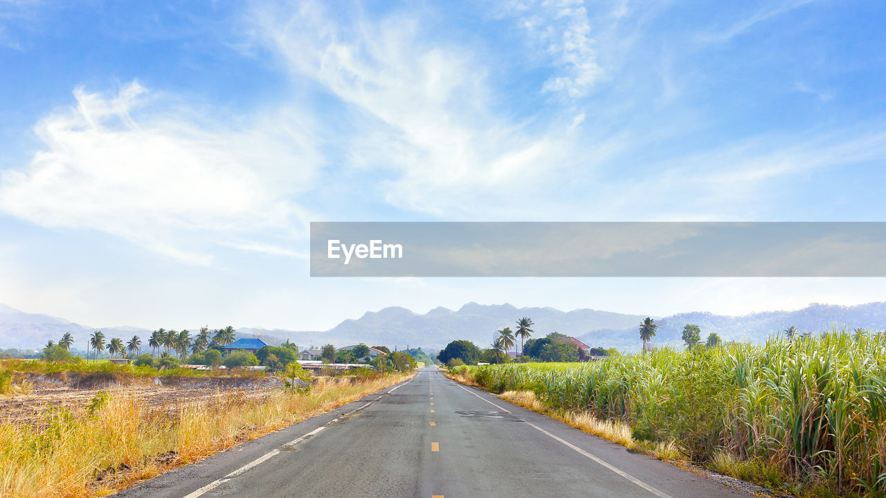 Empty road along countryside landscape