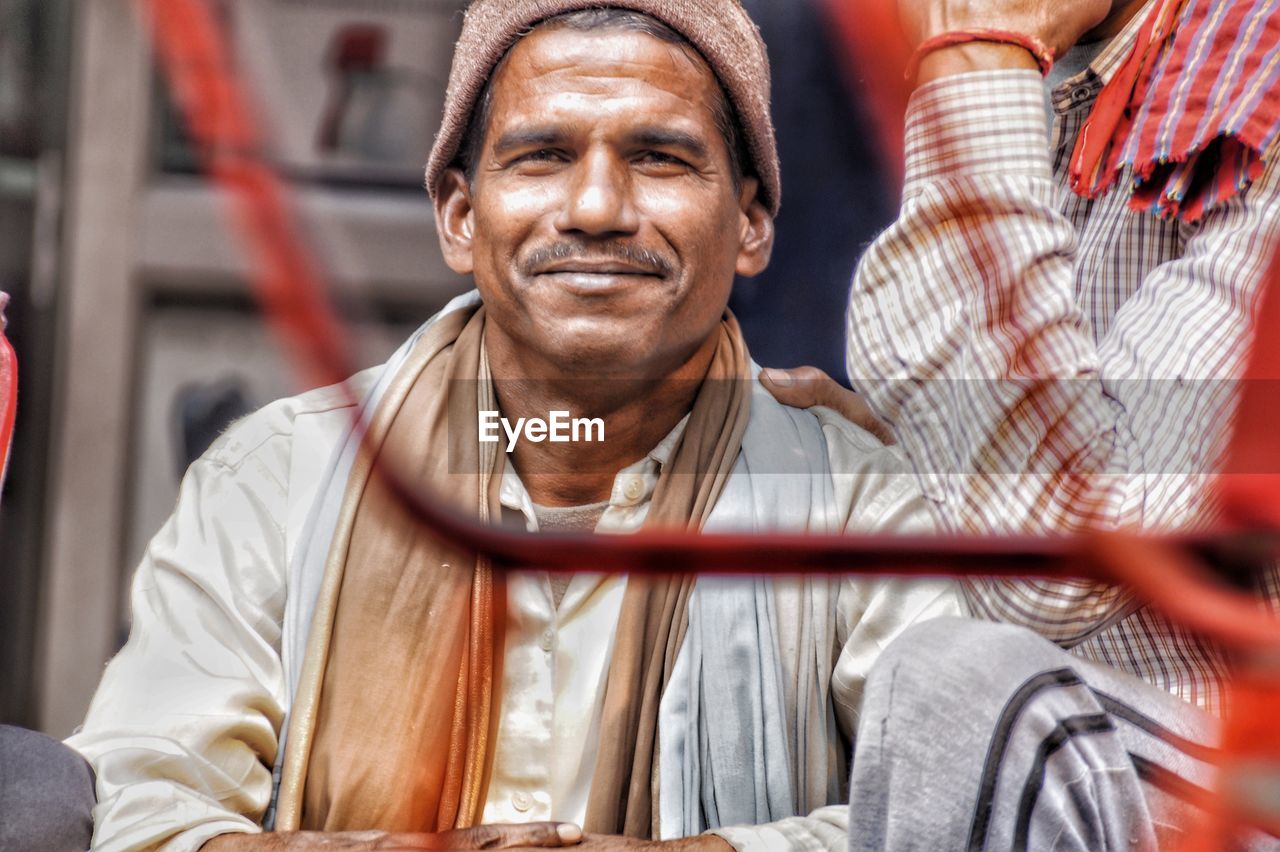 Portrait of smiling man sitting outdoors