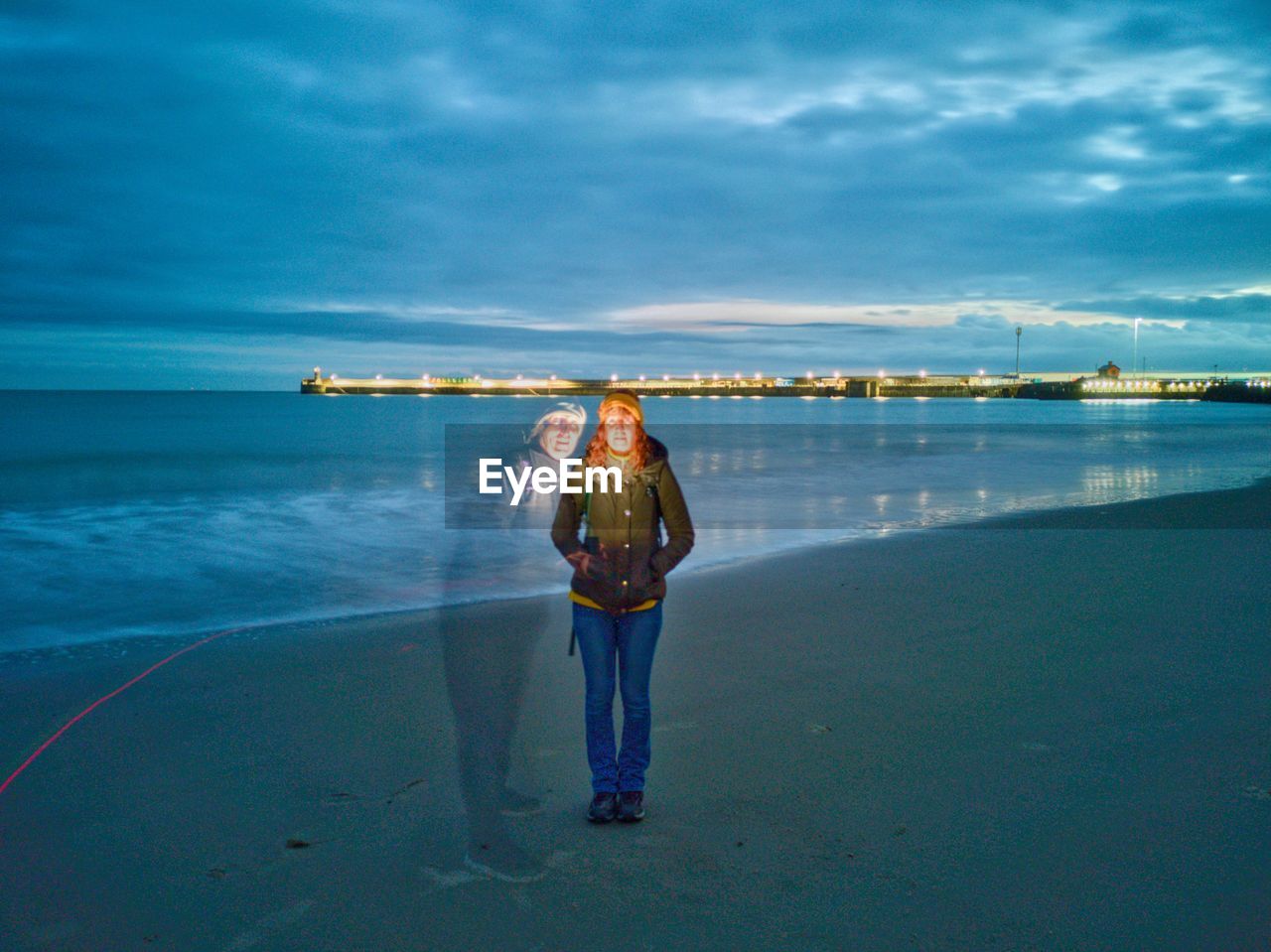 Multiple image of woman standing at beach against cloudy sky