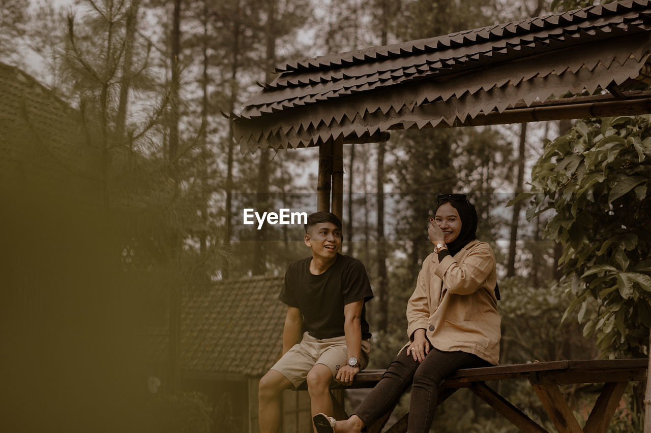 Young couple sitting outdoors