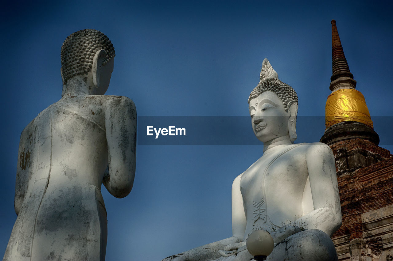 LOW ANGLE VIEW OF BUDDHA STATUE AGAINST SKY