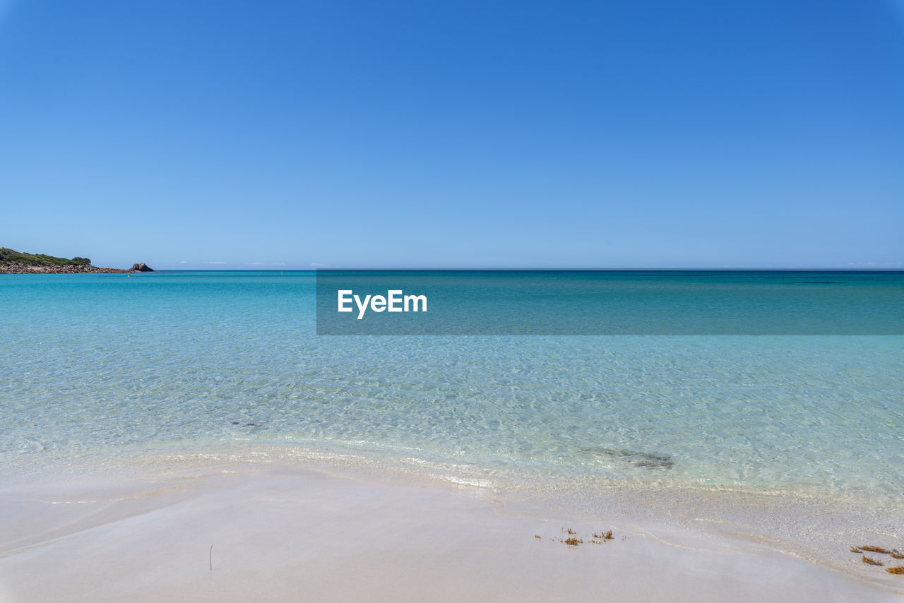 Scenic view of sea against clear blue sky