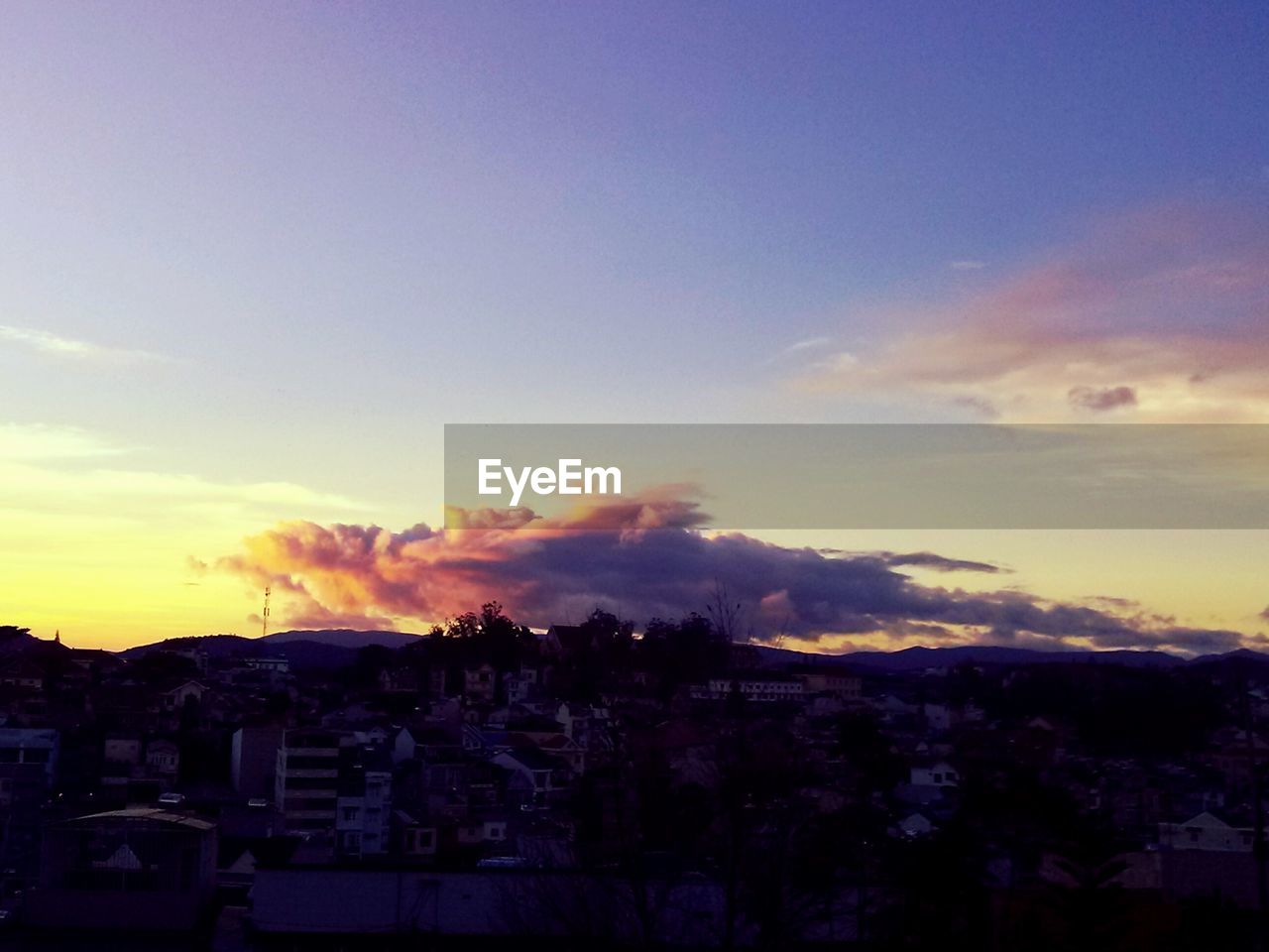 VIEW OF BUILT STRUCTURES AGAINST SUNSET