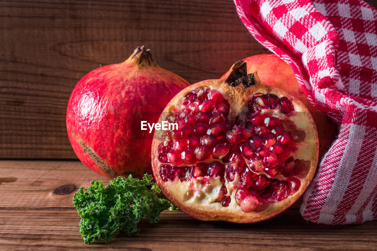 Natural pomegranate on rustic wooden background