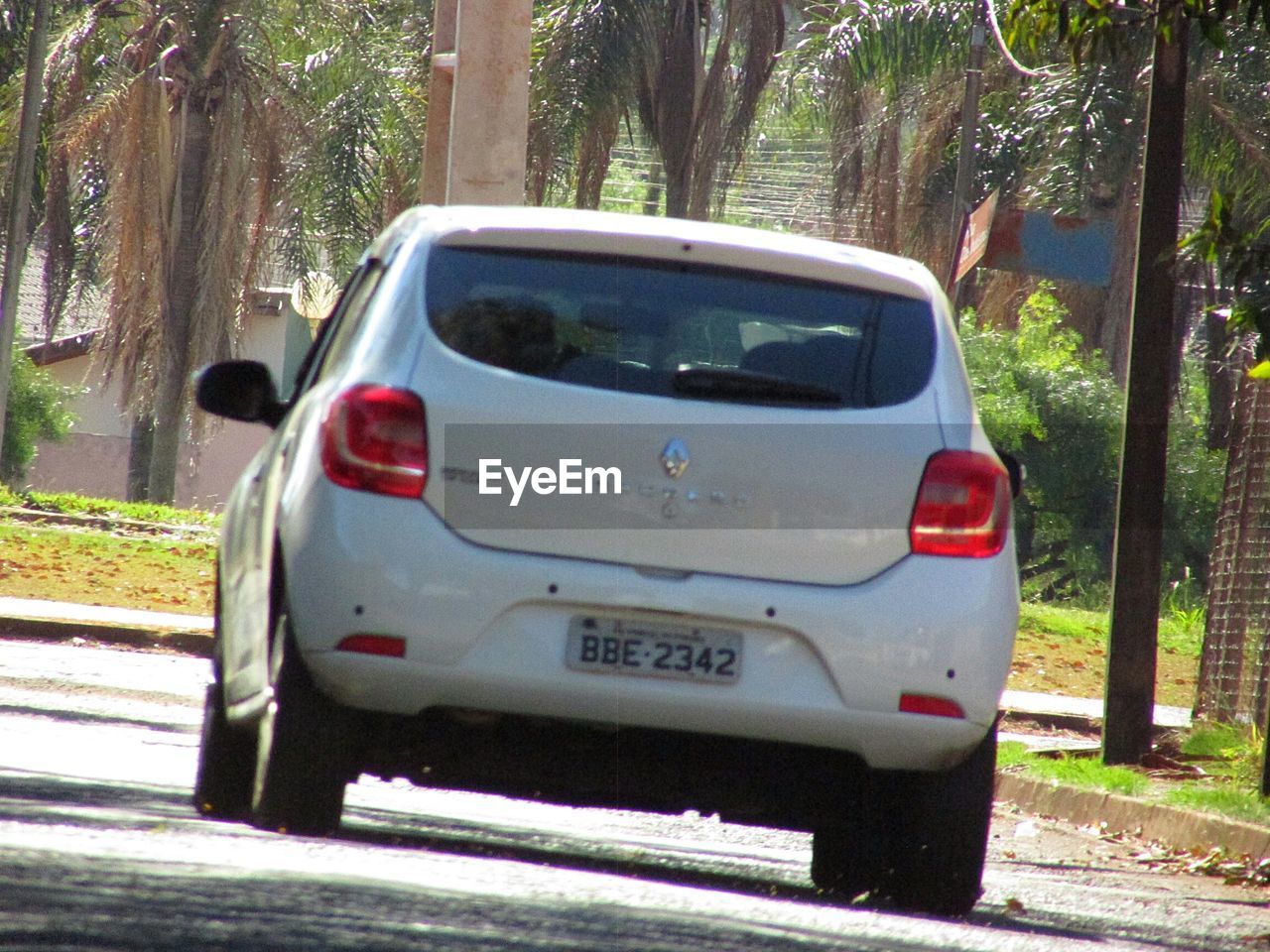 VIEW OF CAR ON ROAD IN CITY