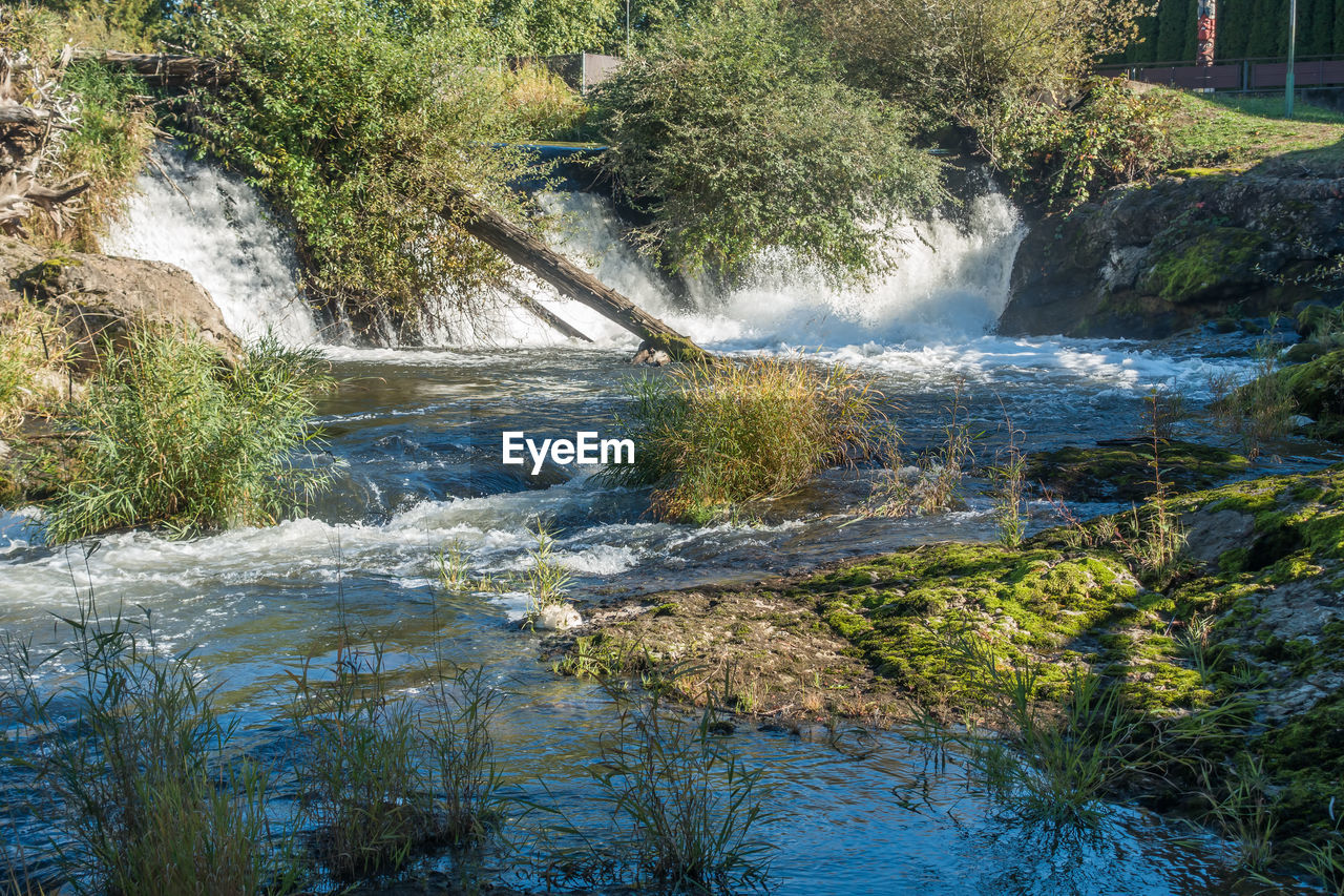 SCENIC VIEW OF WATERFALL IN RIVER