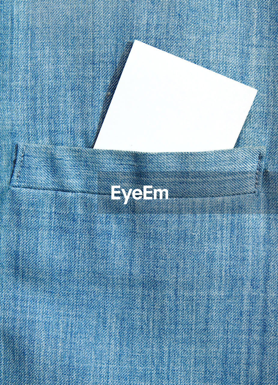 Full frame shot of patterned shirt with blank paper
