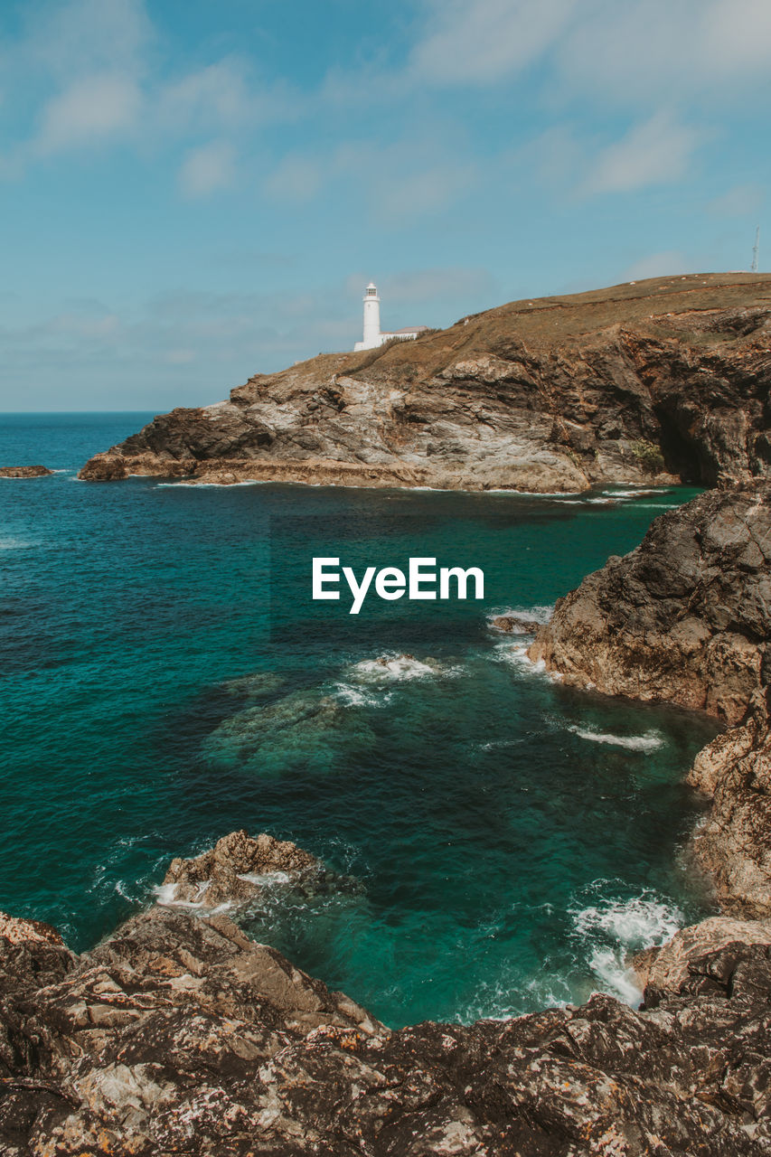 Scenic view of sea against sky and a lighthouse on the coast