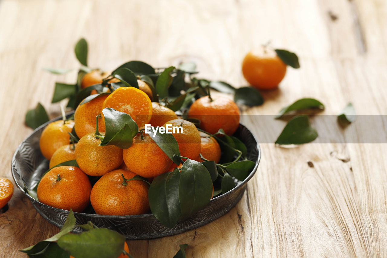 Mandarin orange for imlek chinese new year, served on wooden table. copy space for text