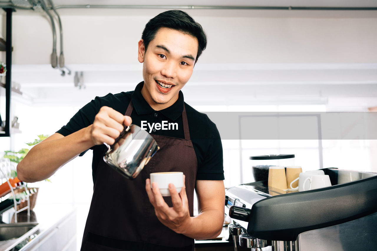 SMILING YOUNG MAN HAVING FOOD