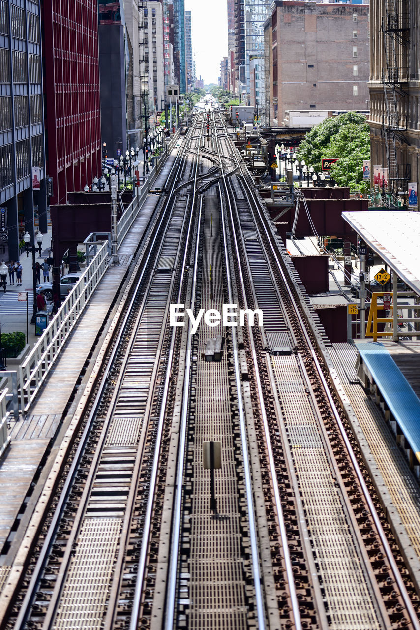 High angle view of railroad tracks amidst buildings in city