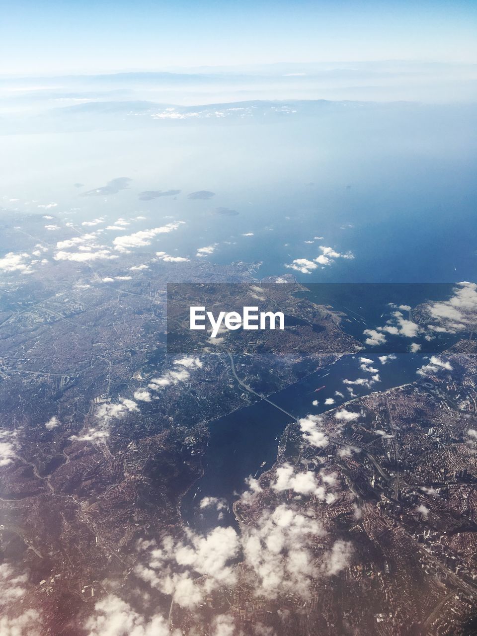 High angle view of sea and land against sky