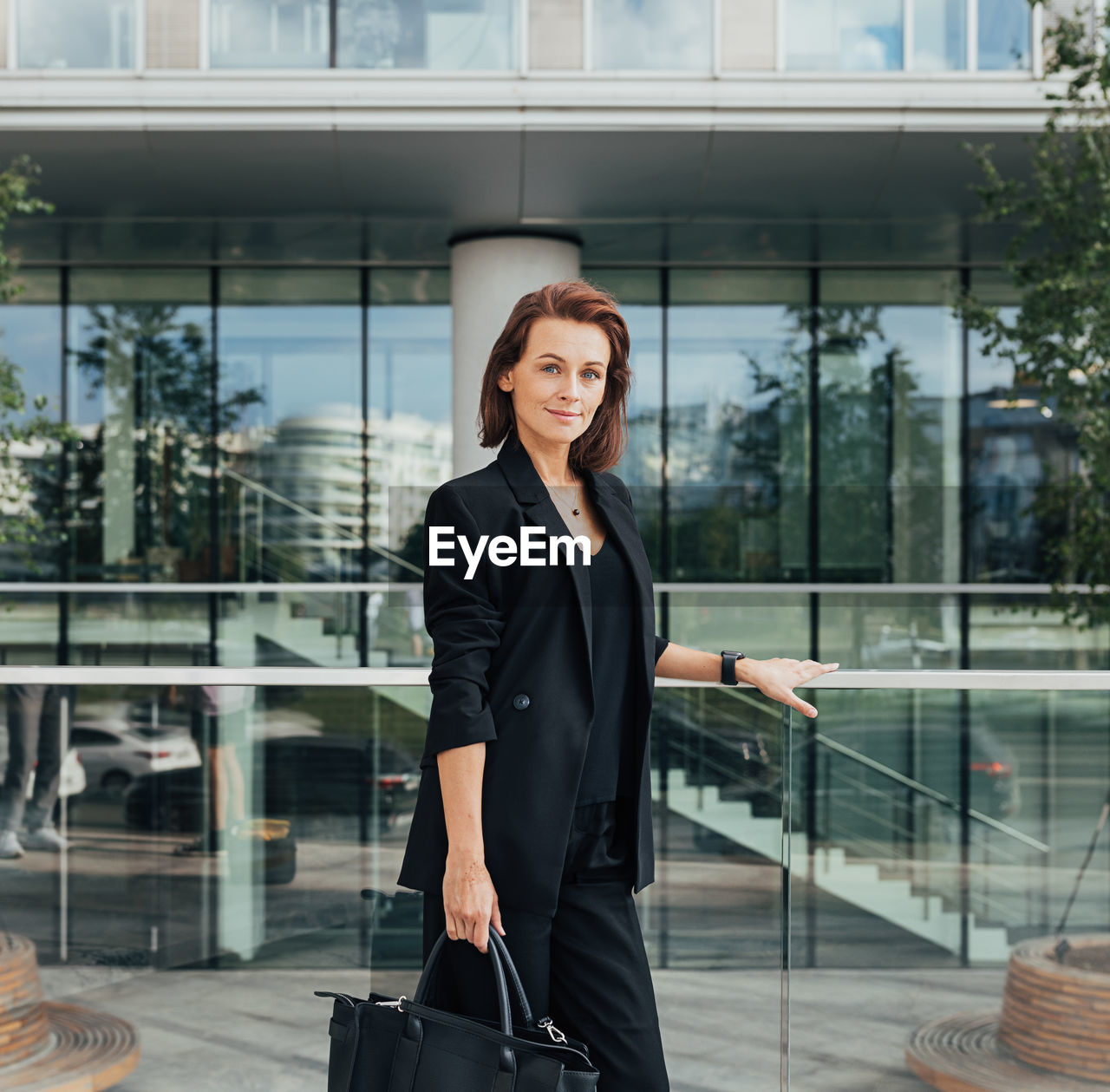 portrait of young businesswoman standing in city