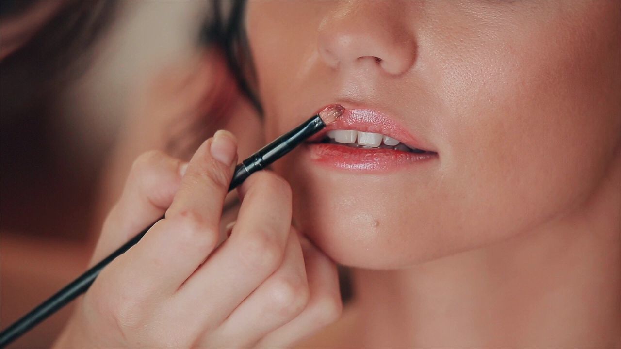 Close-up of woman applying lipstick