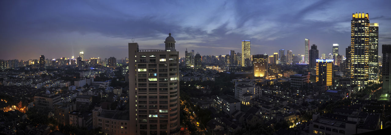 Illuminated cityscape against sky at night