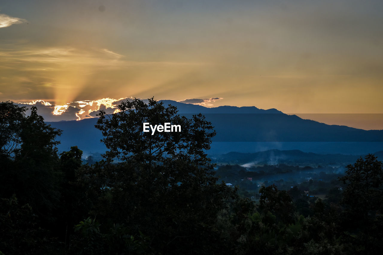 Scenic view of silhouette mountains against sky at sunset