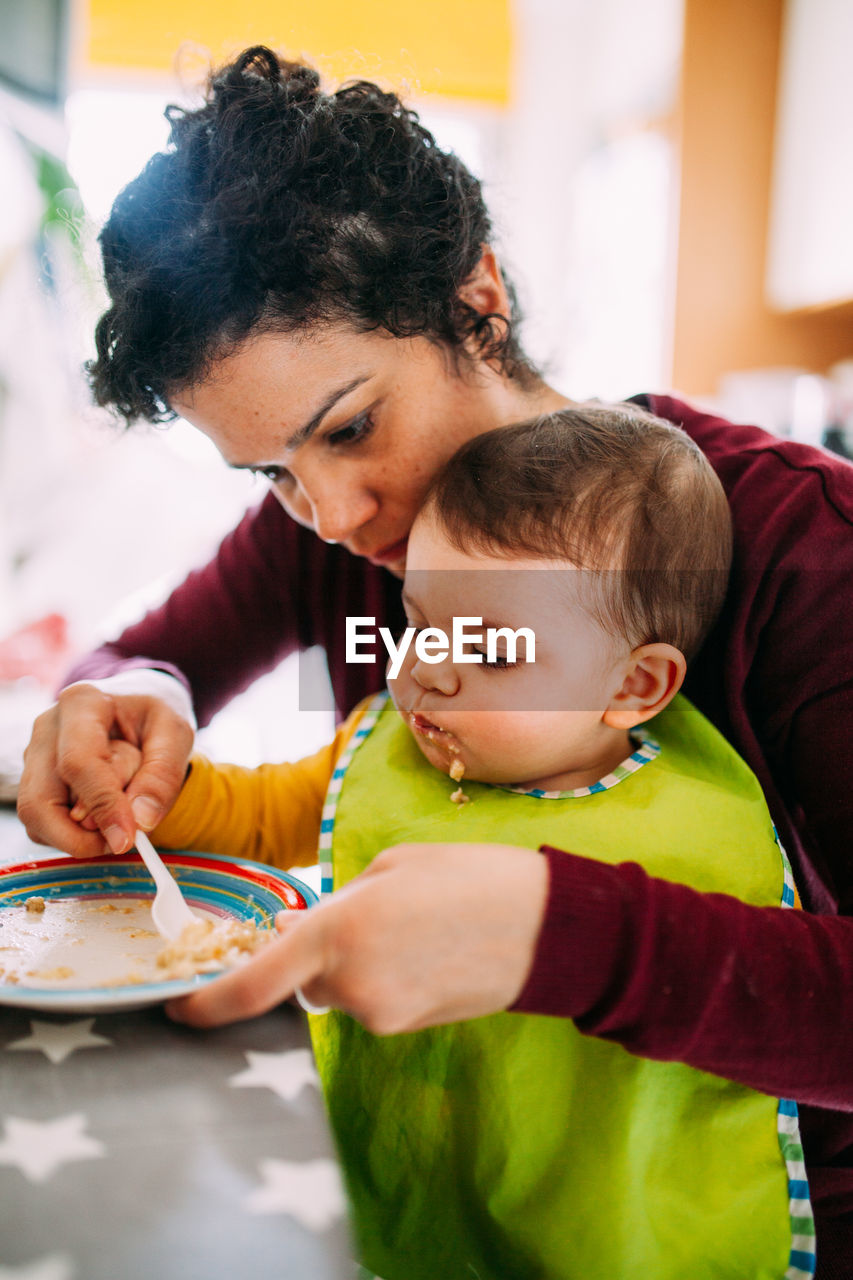 Mother and daughter having food at home