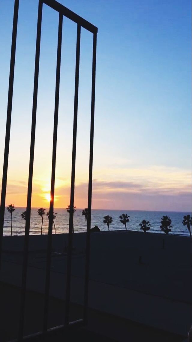 SILHOUETTE BEACH BY SEA AGAINST SKY DURING SUNSET