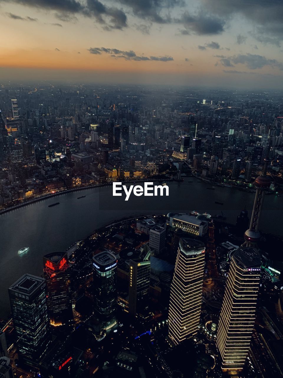 AERIAL VIEW OF ILLUMINATED CITY BUILDINGS AGAINST SKY