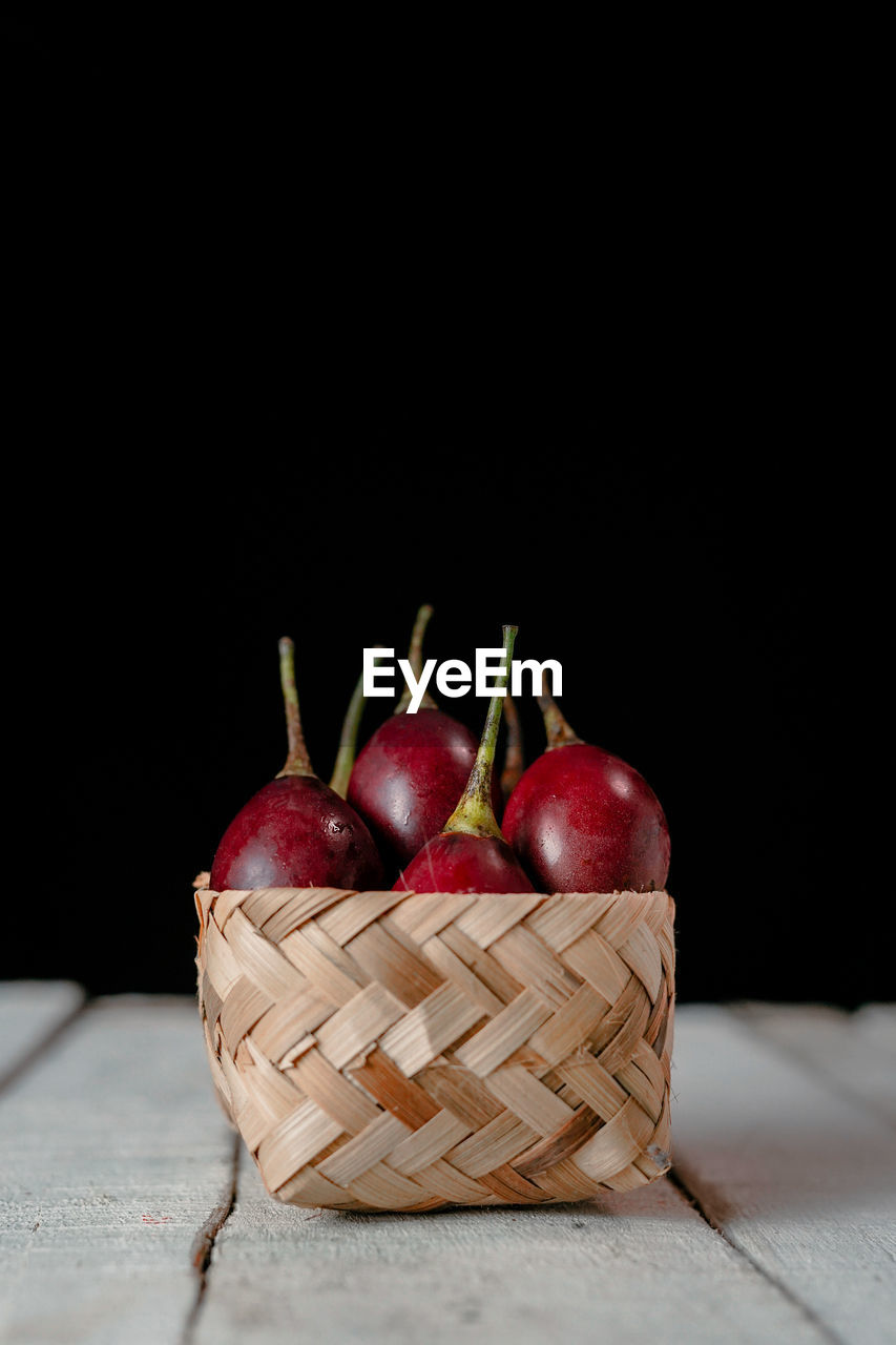 CLOSE-UP OF FRUITS IN BASKET