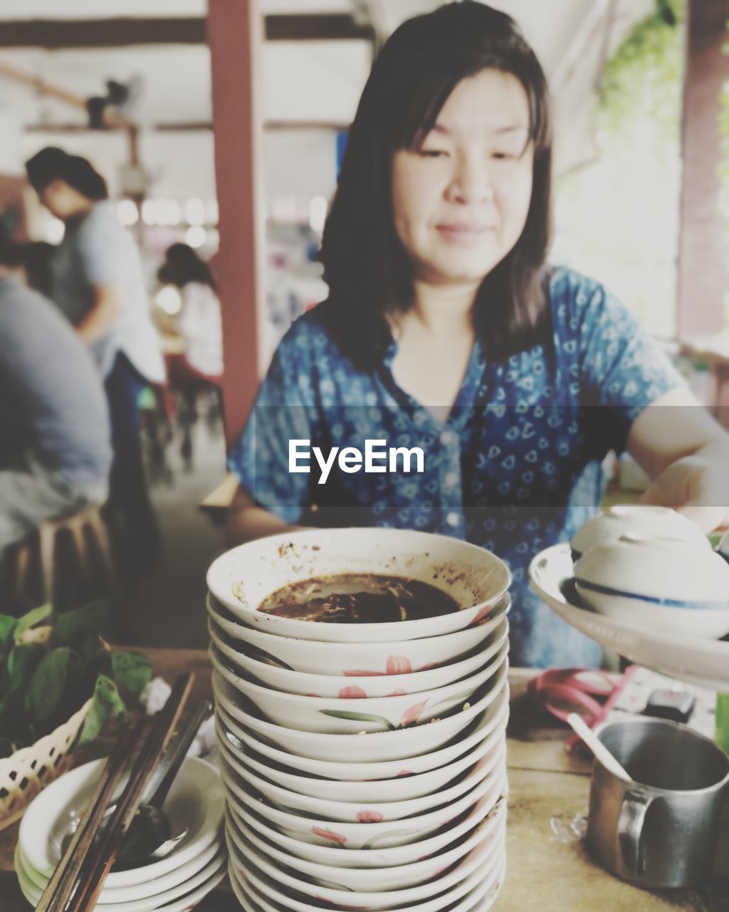 Mature woman having food while sitting in restaurant