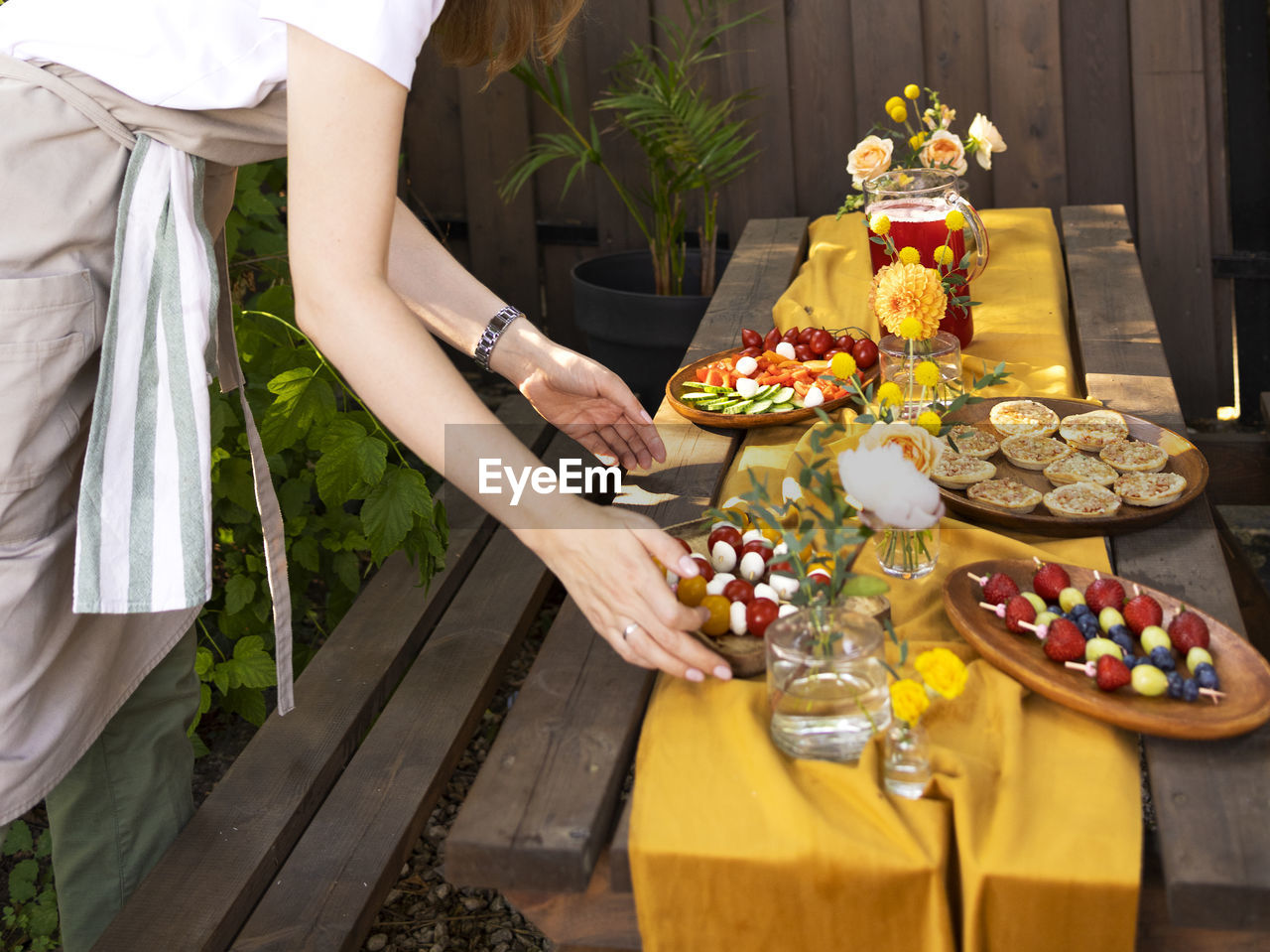 midsection of woman holding christmas decorations on table