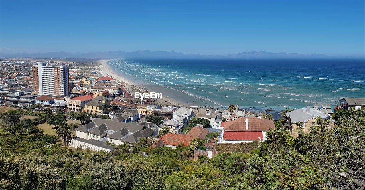 HIGH ANGLE VIEW OF BUILDINGS AND SEA