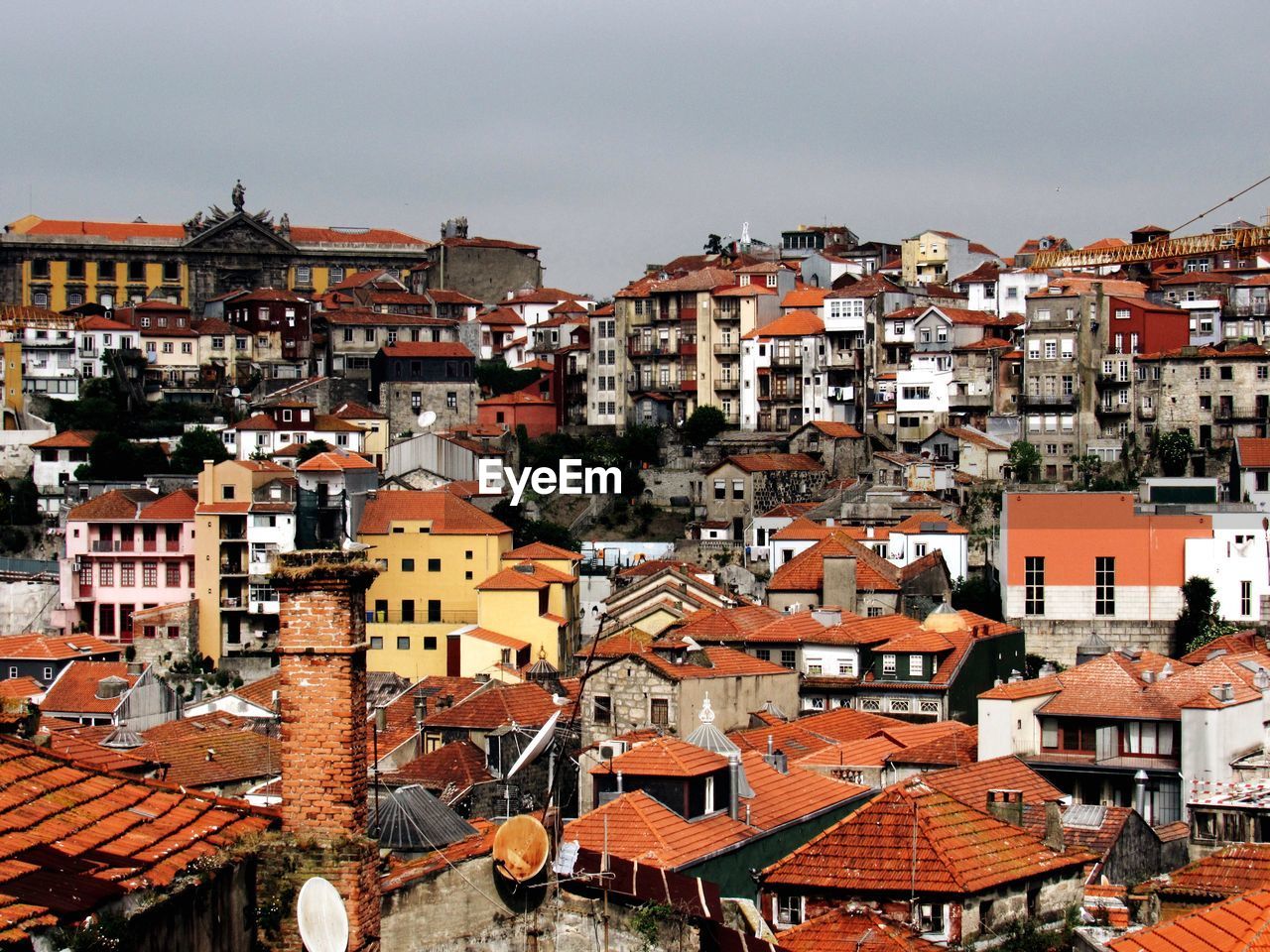 High angle view of houses in town against sky