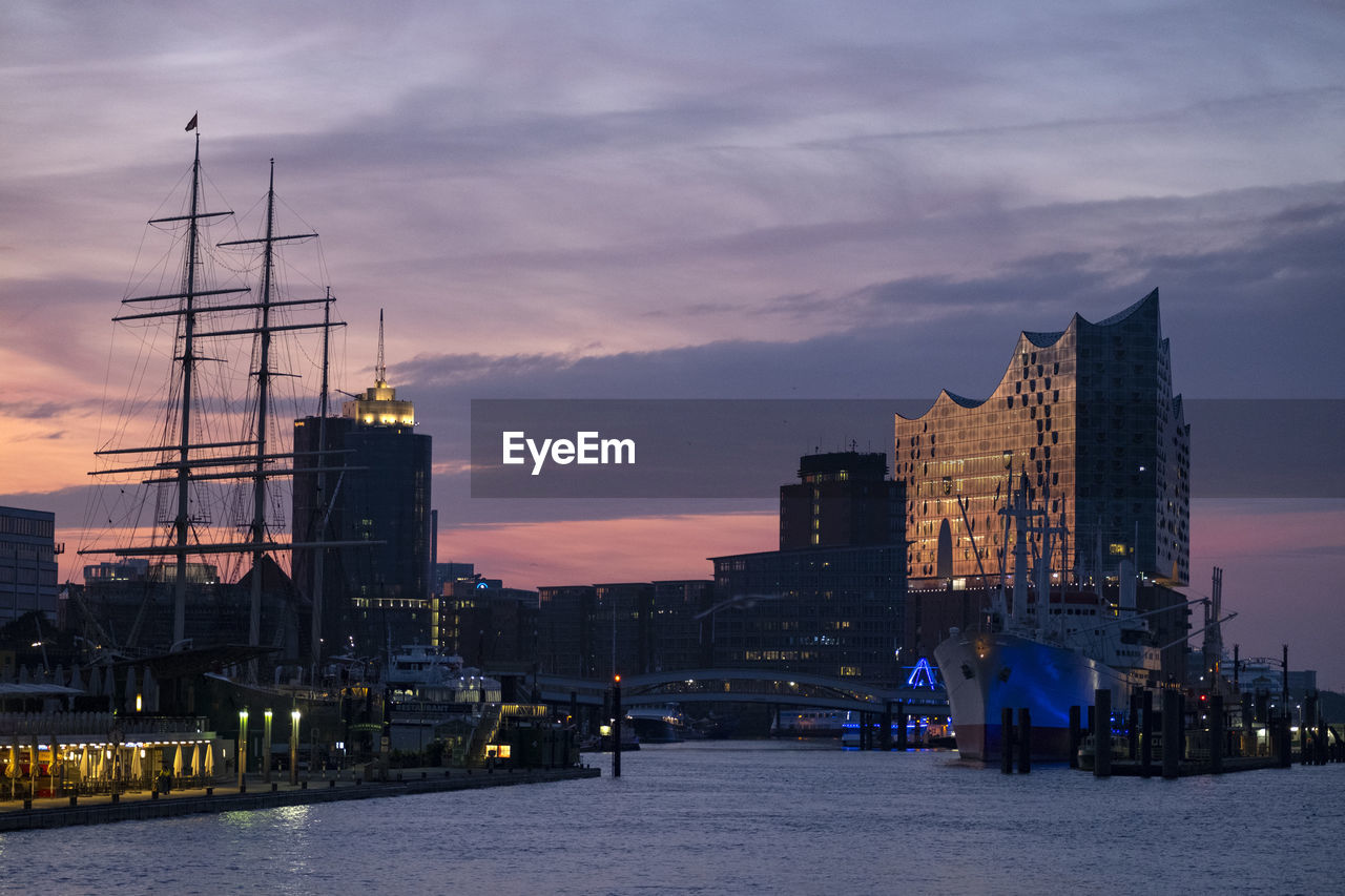 ILLUMINATED BUILDINGS AGAINST SKY AT SUNSET