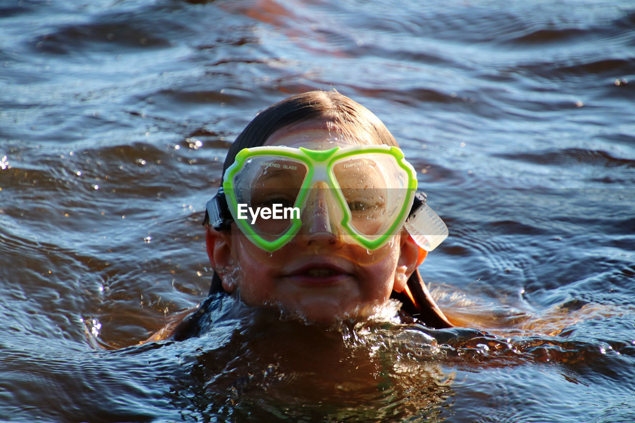 Portrait of child swimming in sea