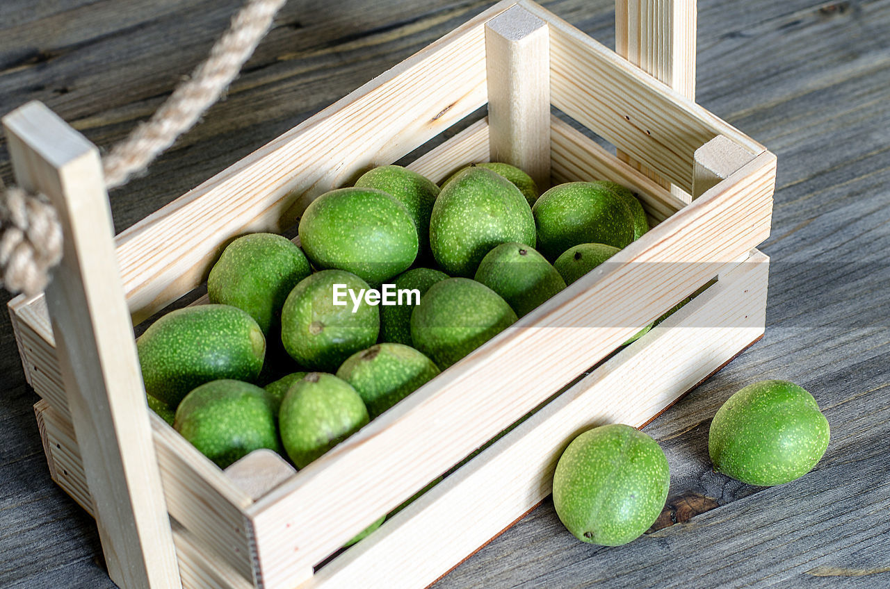 HIGH ANGLE VIEW OF FRUITS IN CONTAINER ON TABLE